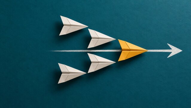 Group of white paper airplanes led by a yellow paper airplane following direction arrow representing teamwork leadership and business strategy
