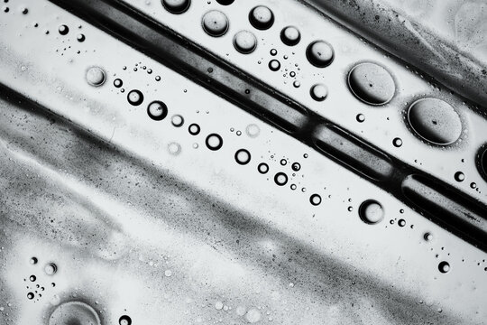 Monochrome oil and water bubbles in an abstract macro pattern