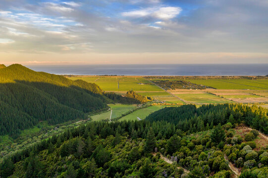 Forested hills with farmland and coastal ocean horizon