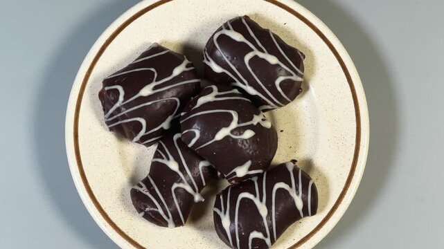 Gingerbread cookies with chocolate glaze coating on saucer