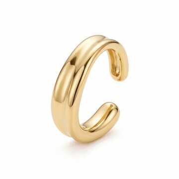 Gold ear cuff with a modern elegant style, shiny golden finish in bright studio lighting, isolated polished metallic accessory for e-commerce product photography.