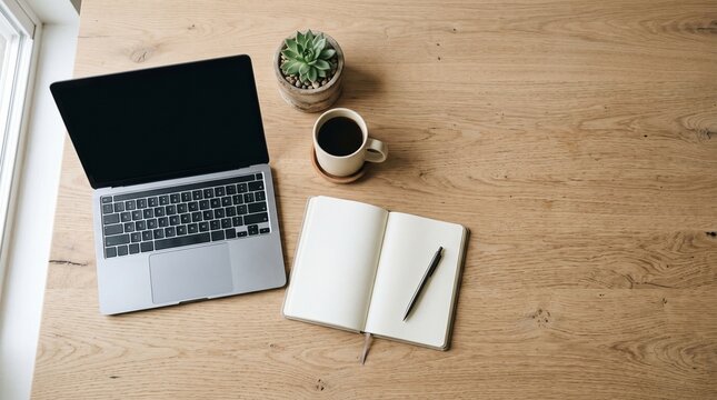 Modern Workspace Setup with Laptop Notebook Coffee and Plant on Wooden Desk
