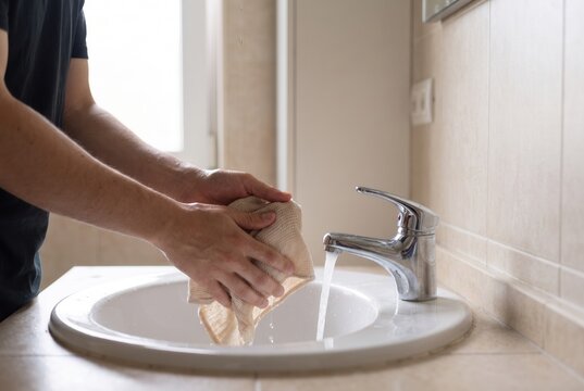 Close up of hands washing at a bathroom sink