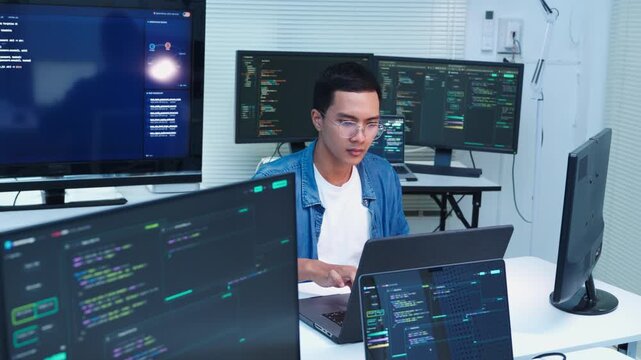 Programmer Coding Software Application on Multiple Monitors