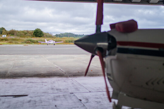 small plane parked in the airfield hangar