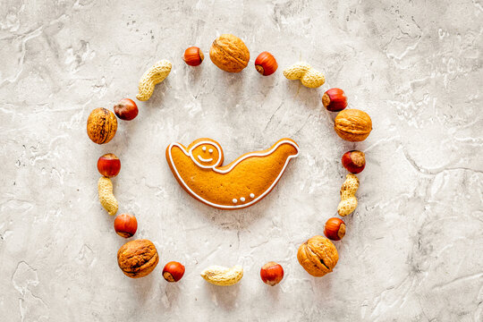 Healthy food for sportsman. Cookies in shape of yoga asanas near nuts on stone background top view mock up