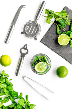 Make mojito cocktail with lime and peppermint. White background top view