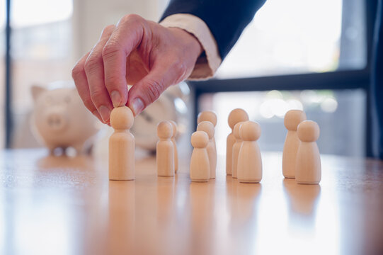 Businessman or HR manager choosing wood doll in concept of Human resources, HR is searching for a right person for a job position. Recruitment with high ai technology skills