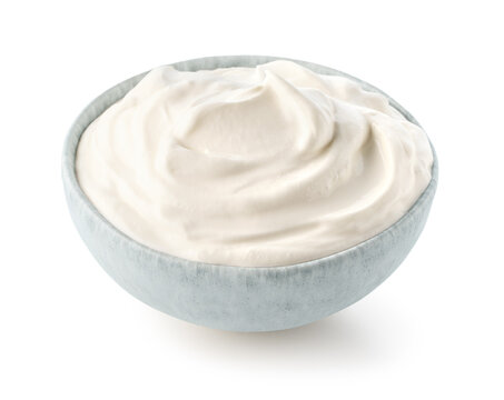 Light blue ceramic bowl of fresh sour cream or greek yogurt