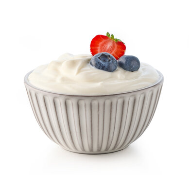 Gray ceramic bowl of fresh greek yogurt with berries on white background