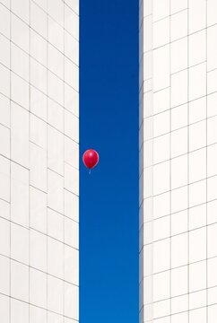 Minimalist Architectural View with Floating Red Balloon