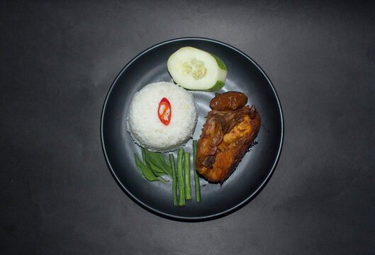 indonesian fried chicken with spicy sambal warm rice and vegetable also known as ayam lalapan