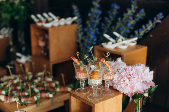 Elegant wedding buffet with shrimp cocktail appetizers and floral decor