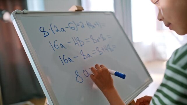Boy solving math equation whiteboard. Dad high five, proud happy success home.
