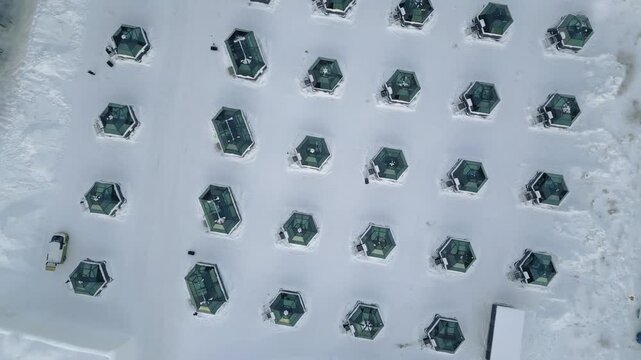 Aerial top down view luxury glass igloos snowy winter landscape unique accommodation luxury hospitality Arctic tourism concept