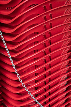 Graphic close up of stack of red plastic chairs