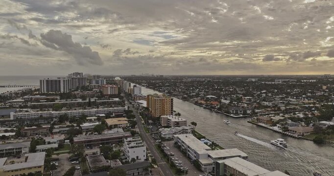 Pompano Beach Florida Aerial v4 low flyover above the Intracoastal channel past waterfront buildings, boats and residential canals - Shot with 5k Camera - Dec 10th 2023
