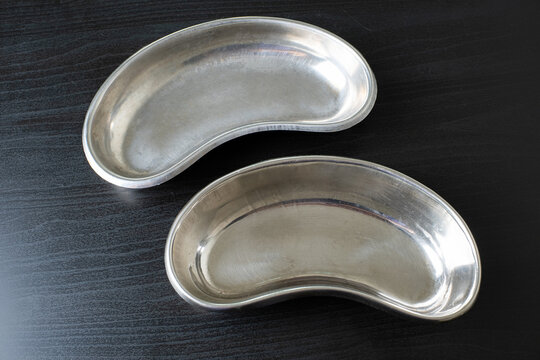 Stainless steel medical tray, kidney-shaped bowl for medical procedures.