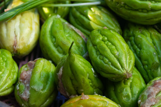 Fresh raw green bitter melons stuffed with seasoned minced pork ready for cooking traditional Vietnamese soup