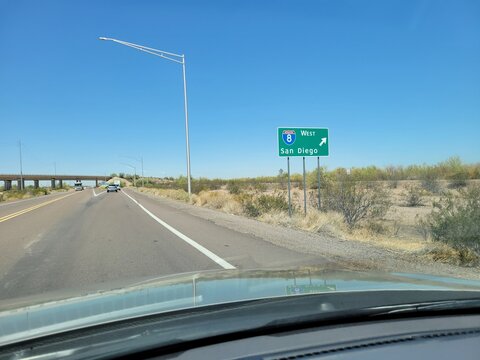 Driving west toward San Diego and I-8 interstate freeway in a desert environment near city of Gila Bend, Arizona