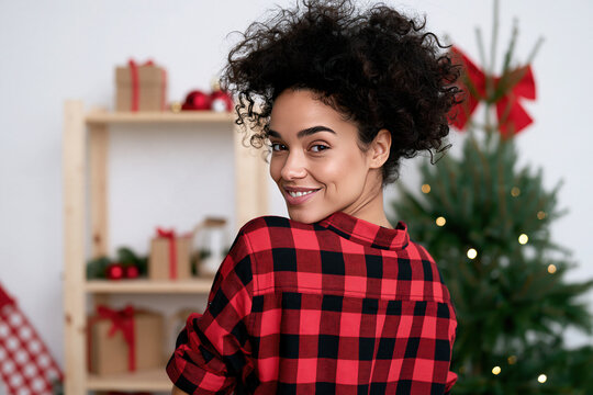 Afro american girl smiling wearing flannel shirt, christmas accessory background