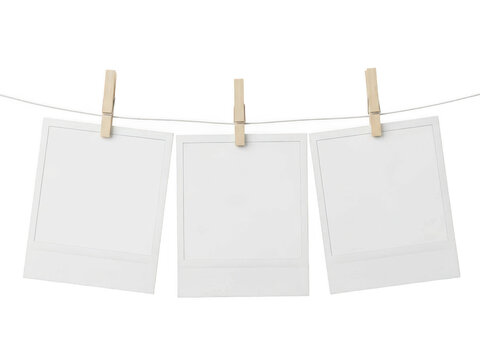 Three blank paper cards hanging on a clothesline