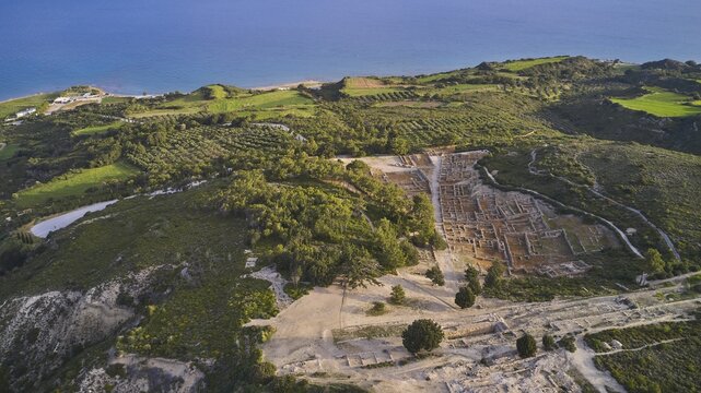 Drone shot, first morning light, aerial view of ancient ruins near the sea, embedded in green landscapes and hills, Kamiros, archaeological site, ancient city, foundation of Doric Greeks, Rhodes, Dodecanese, Greek Islands, Greece