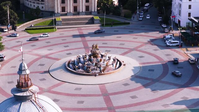 Drone view of the traffic circling the Colchis Fountain in the central square of Kutaisi, Georgia