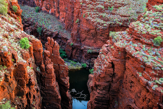 Looking down into a deep red canyon with water below