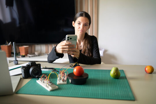 Engineer Using Smartphone to Capture Tomato Weight Data for AI Recognition System