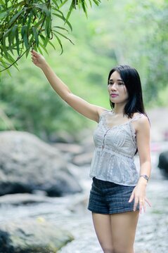 Woman Enjoying Nature at Wang Takrai Waterfall in Nakhon Nayok, Thailand