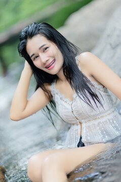 Smiling Woman Swimming by Wang Takrai Waterfall in Nakhon Nayok