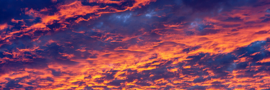 Dramatic orange and purple clouds in sunset sky