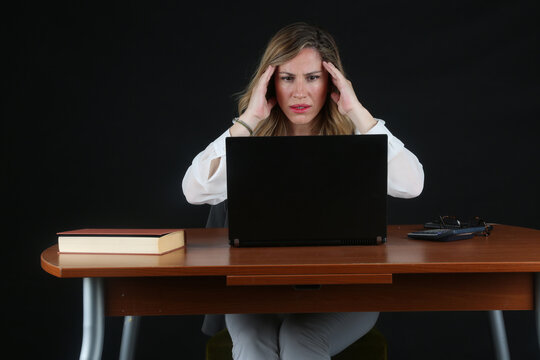 Professional Blonde Businesswoman Working with Laptop Computer at Office Desk