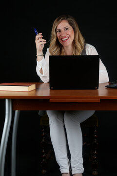 Professional Blonde Businesswoman Working with Laptop Computer at Office Desk