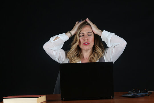 Professional Blonde Businesswoman Working with Laptop Computer at Office Desk