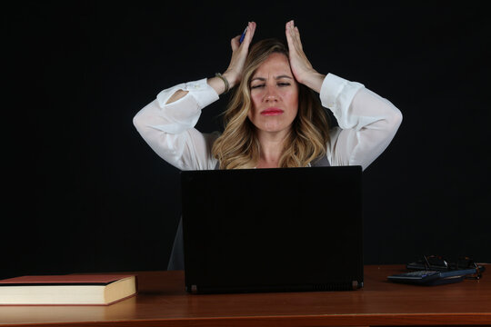 Professional Blonde Businesswoman Working with Laptop Computer at Office Desk