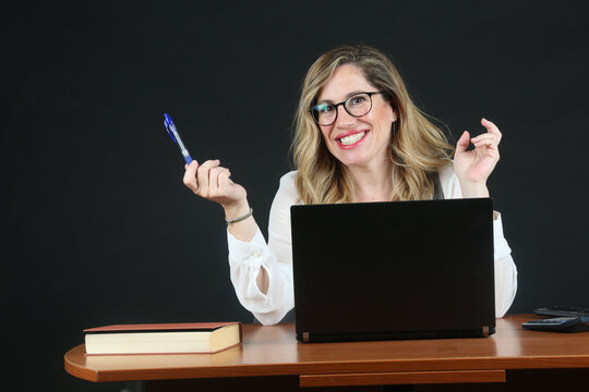 Professional Blonde Businesswoman Working with Laptop Computer at Office Desk