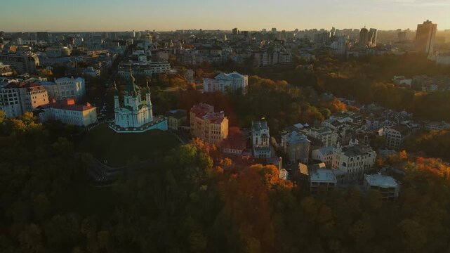 High aerial panorama of Saint Andrew Church and golden autumn foliage in Kyiv