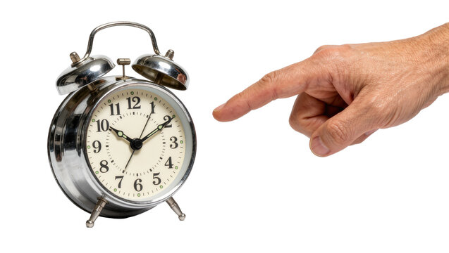 Human hand pointing at a vintage chrome twin bell alarm clock