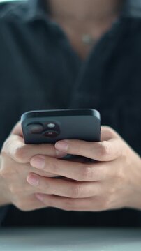 woman holds smart phone in her hands and scrolls through the news feed. Close up of hand uses mobile. point finger on screen, texting text message.