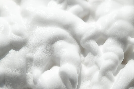 Soap foam creates soft bubbles and creamy lather texture in a clean studio close-up