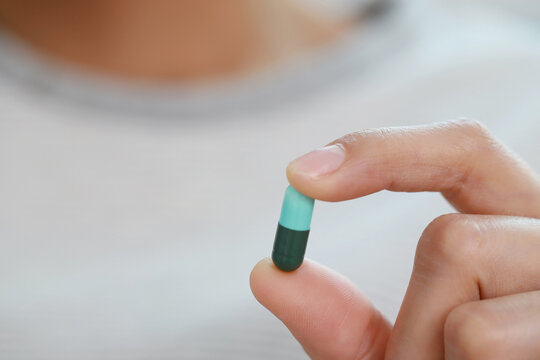 close up woman hand holding a medicine Anti-inflammatory. Stop drug use Taking Medication Caring for the health care medical concept.