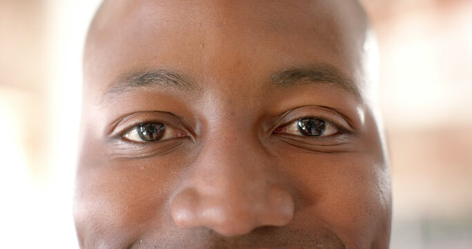 Eyes of happy african american casual businessman standing in office