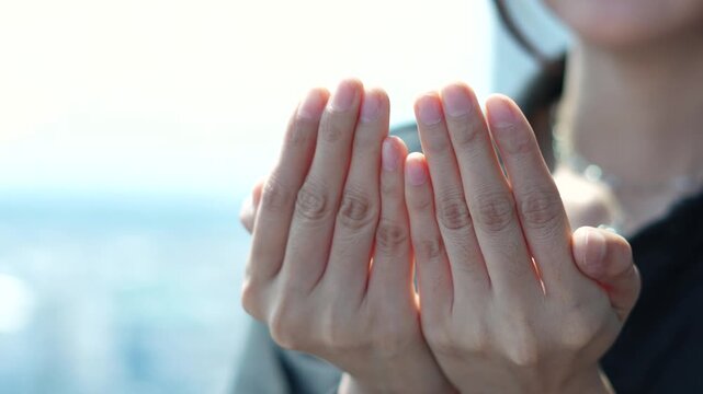 woman hands clasped together in prayer. Concept of faith, hope, spirituality, and religious devotion.