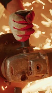An Intense Close-Up of a Skilled Craftsman Operating a Power Tool, Showcasing the Precision and Focus Required in Metalworking and Fabrication Work.