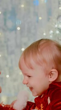 Heartwarming Moments: A Joyful Mother and Her Child Celebrating Together in Festive Red Attire with Holiday Spirit and Warm Smiles at a Cheerful Gathering