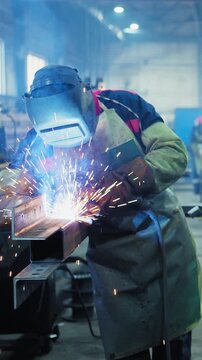 Skilled Welder in Action Creating Sparks and Connecting Metal Parts in an Industrial Workshop with Focused Precision and Safety Gear for Maximum Efficiency