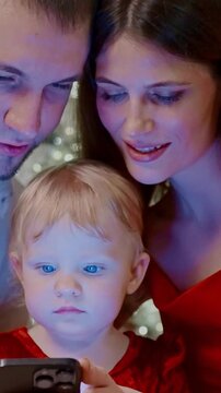 Family Moments: Joyful Interactions of Parents and Child Engaged with a Smartphone, Capturing a Heartwarming Scene Full of Connection and Togetherness