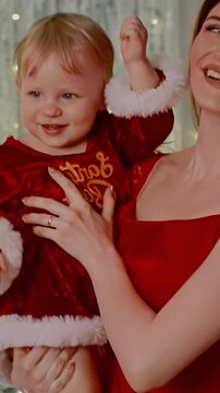 Joyful Moments: A Mother and Child Celebrate Together in Festive Attire with Holiday Cheer and Smiles Amidst a Beautifully Decorated Background